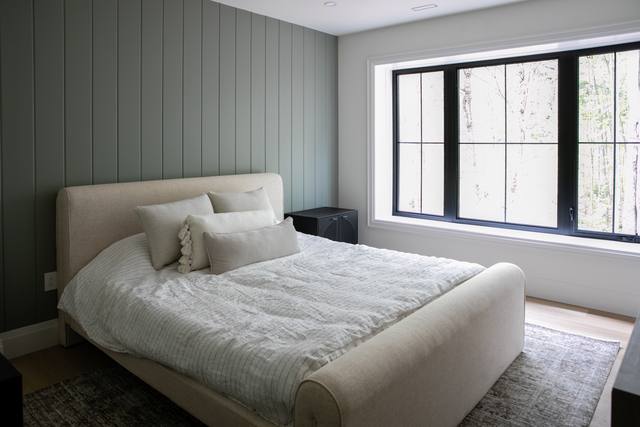 Bedroom with large black-framed window